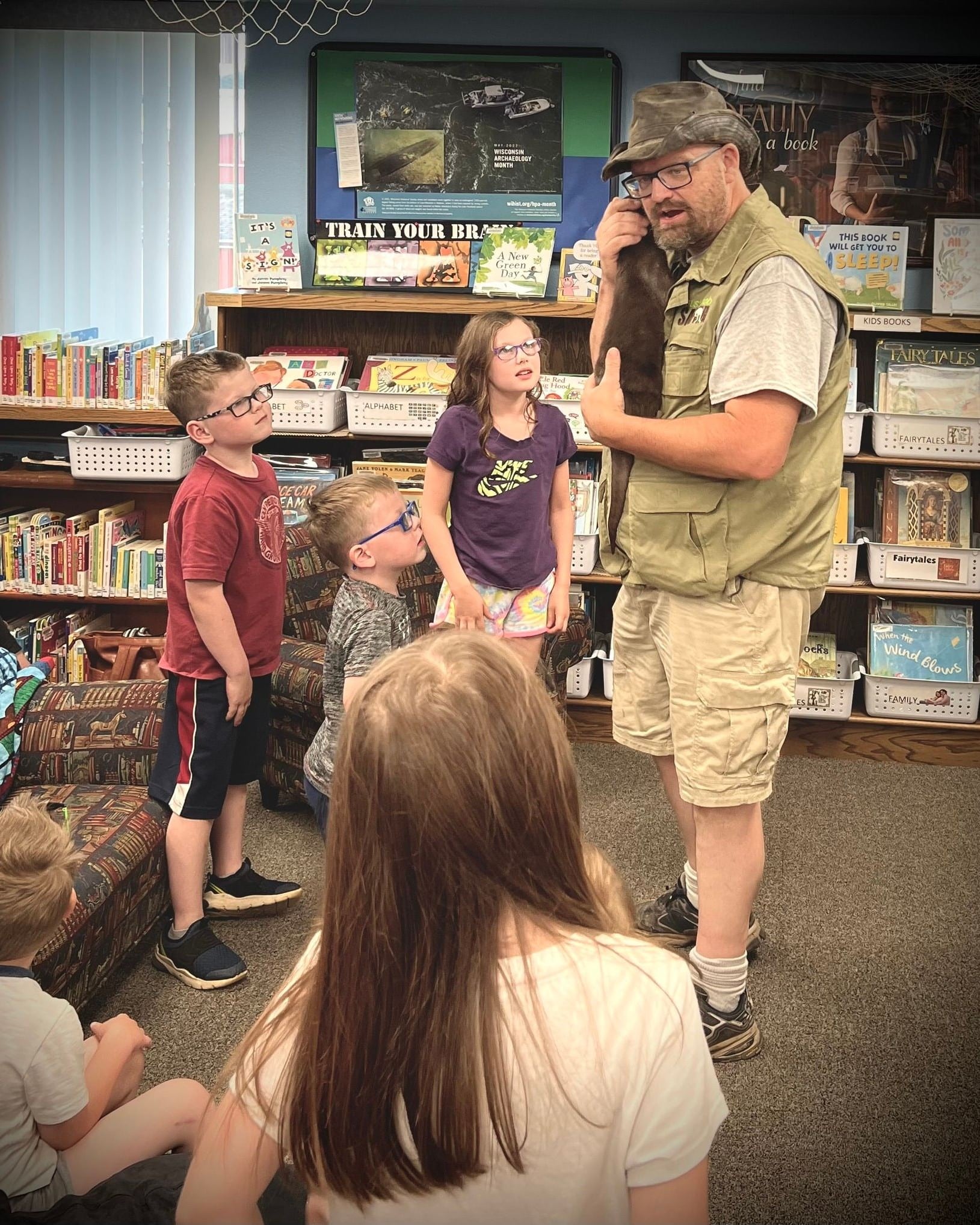 Safari Bob showing children an otter at a daycare center