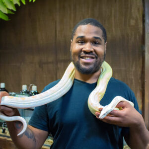 man holding a large snake